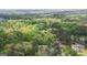 An aerial view of a home surrounded by dense trees in a forest area. The home is circled in white at 4360 Derrick Rd, South Fulton, GA 30349