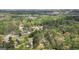 An aerial view of a home surrounded by dense trees in a forest area. The home is circled in white at 4360 Derrick Rd, South Fulton, GA 30349