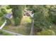 Aerial view of a two-story home with a landscaped front yard surrounded by lush greenery. The home is circled in white at 4360 Derrick Rd, South Fulton, GA 30349