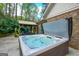 Backyard with a hot tub, an outdoor seating area, and well-maintained landscaping at 4360 Derrick Rd, South Fulton, GA 30349