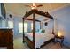 Inviting bedroom with a four poster bed, plush carpets, and ample natural light at 4360 Derrick Rd, South Fulton, GA 30349