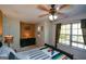 Cozy bedroom with a ceiling fan, natural light from the window, and a warm-toned accent wall at 4360 Derrick Rd, South Fulton, GA 30349