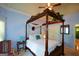 Elegant bedroom featuring a four-poster bed with ornate details and soft, natural light at 4360 Derrick Rd, South Fulton, GA 30349