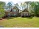 Charming two-story home featuring a well-maintained lawn and lush landscaping at 4360 Derrick Rd, South Fulton, GA 30349