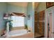 Enjoy a private soak in the tub or a refreshing shower in this serene main bathroom at 4360 Derrick Rd, South Fulton, GA 30349