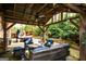 Outdoor patio with covered area, comfortable seating, and a view of the landscaped backyard at 4360 Derrick Rd, South Fulton, GA 30349