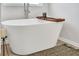 Relaxing white soaking tub featuring a wooden tray, perfect for unwinding in style at 5364 Tolar Road # 74, South Fulton, GA 30213