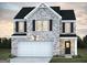 Charming two-story home featuring gray brick, black shutters, and an attached two-car garage at 5364 Tolar Road # 74, South Fulton, GA 30213