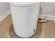 Close-up of a modern white toilet with wood-look flooring in a cozy bathroom setting at 5364 Tolar Road # 74, South Fulton, GA 30213