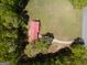 Overhead view of red-roofed house with long driveway and expansive grassy yard bordered by trees at 361 Cecil Hunter Rd, Moreland, GA 30259