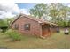 Exterior view of a brick home featuring a metal roof, and a well-maintained lawn at 361 Cecil Hunter Rd, Moreland, GA 30259