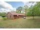 Exterior view of a brick home with a metal roof and spacious yard at 361 Cecil Hunter Rd, Moreland, GA 30259