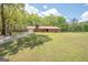 Exterior view of a brick home featuring a metal roof, attached garage, and driveway at 361 Cecil Hunter Rd, Moreland, GA 30259