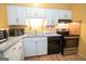 Modern kitchen featuring white cabinets, updated appliances, and ample counter space at 361 Cecil Hunter Rd, Moreland, GA 30259