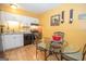 Well-lit kitchen featuring white cabinets, modern appliances and a glass-top dining table with four chairs at 361 Cecil Hunter Rd, Moreland, GA 30259