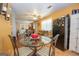 Spacious area with kitchen and dining area featuring a glass table, black refrigerator, and ample seating at 361 Cecil Hunter Rd, Moreland, GA 30259