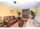 Cozy living room featuring a brick fireplace, comfortable sofas, and bright accents at 361 Cecil Hunter Rd, Moreland, GA 30259