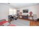 Comfortable living room with modern furniture, laminate floors, and a large window at 361 Cecil Hunter Rd, Moreland, GA 30259