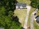 Beautiful aerial view of a home with a large, well-maintained front lawn and a long driveway at 214 Windgate Ct, Peachtree City, GA 30269