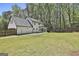 Expansive backyard featuring a well-maintained lawn, a two-story home, and privacy fence with trees in the background at 214 Windgate Ct, Peachtree City, GA 30269