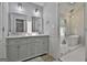 Elegant bathroom featuring dual sinks, modern fixtures, and a glass-enclosed shower with a soaking tub at 214 Windgate Ct, Peachtree City, GA 30269