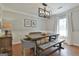 Dining room showcasing a decorative light fixture and a farmhouse-style table with bench seating at 214 Windgate Ct, Peachtree City, GA 30269