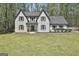 Charming two-story home featuring a grey roof, white brick facade, and well-manicured front yard at 214 Windgate Ct, Peachtree City, GA 30269