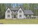 Charming two-story home featuring a grey roof, white brick facade, and well-manicured front yard at 214 Windgate Ct, Peachtree City, GA 30269