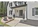 Charming front entrance with a brick facade, black shutters, and meticulously landscaped planters at 214 Windgate Ct, Peachtree City, GA 30269
