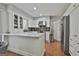 White kitchen with stainless appliances, a peninsula, and black subway tile backsplash at 214 Windgate Ct, Peachtree City, GA 30269