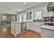 Bright and open kitchen with island, stainless dishwasher, and wood flooring at 214 Windgate Ct, Peachtree City, GA 30269