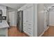Kitchen area with a stainless steel refrigerator, white pantry cabinets, and wood-look flooring at 214 Windgate Ct, Peachtree City, GA 30269