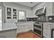 Bright kitchen with stainless steel appliances, quartz countertops, and display cabinets at 214 Windgate Ct, Peachtree City, GA 30269