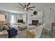 Bright living room with a white brick fireplace, comfortable seating, and a large ceiling fan at 214 Windgate Ct, Peachtree City, GA 30269