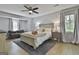 Bright, well-lit main bedroom featuring a ceiling fan, cozy couch, and a queen size bed at 214 Windgate Ct, Peachtree City, GA 30269