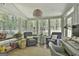 Inviting sunroom with natural light, a ceiling fan, comfortable seating, and views of the outdoors at 214 Windgate Ct, Peachtree City, GA 30269