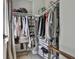Organized walk-in closet with hanging racks, shelves, and shoe storage for efficient storage solutions at 214 Windgate Ct, Peachtree City, GA 30269