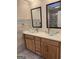 Bathroom featuring dual glass bowl sinks and modern fixtures in a beautifully tiled space at 2316 Emerald Dr, Jonesboro, GA 30236