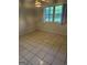 A brightly lit bedroom features durable tile flooring and ample natural light from large windows at 2316 Emerald Dr, Jonesboro, GA 30236