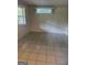 A neutral-toned bedroom features durable tile flooring and ample natural light from large windows at 2316 Emerald Dr, Jonesboro, GA 30236