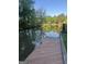 View of the river, a dock, and a concrete boat ramp with landscaping and trees on the property at 2316 Emerald Dr, Jonesboro, GA 30236