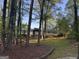 Exterior view of the home featuring a lush front yard with mature trees and landscaped features at 2316 Emerald Dr, Jonesboro, GA 30236