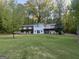 Charming multi-story home boasting a large yard, mature trees, and a full length balcony at 2316 Emerald Dr, Jonesboro, GA 30236