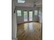 Sun-filled room with wood floors, ceiling fan, and French doors leading to a backyard view at 2316 Emerald Dr, Jonesboro, GA 30236