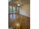 Hardwood flooring with large French doors leading to the back porch, complemented by a ceiling fan at 2316 Emerald Dr, Jonesboro, GA 30236