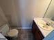 Bathroom with tiled floor, standard toilet, and vanity with sink and faucet at 194 Bay Court Dr, Stockbridge, GA 30281