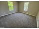 Cozy bedroom featuring plush carpeting and windows allowing natural light at 194 Bay Court Dr, Stockbridge, GA 30281