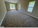 Spacious bedroom featuring large windows and plush carpeting at 194 Bay Court Dr, Stockbridge, GA 30281