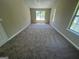 Spacious bedroom featuring large windows and plush carpeting at 194 Bay Court Dr, Stockbridge, GA 30281