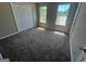 Bedroom featuring carpet, closet and large windows at 194 Bay Court Dr, Stockbridge, GA 30281